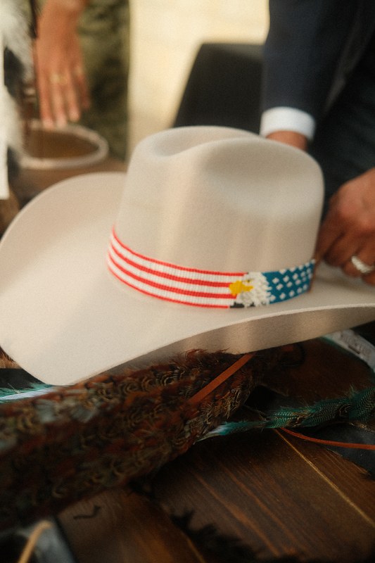 A white Topped Hats western hat finished with a stars and stripes band